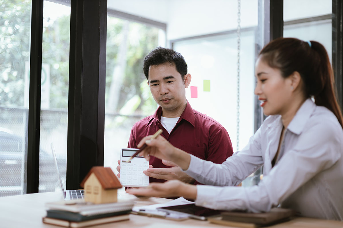 professionals meet with clients to discuss real estate investing, sales, and mortgage options.