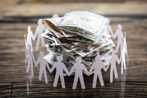 Paper Cut Out Human Figure Surrounding Stacked Banknotes