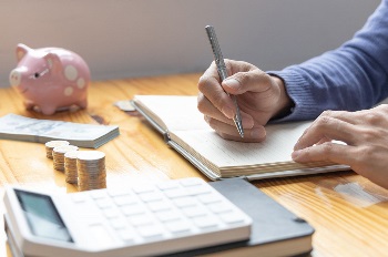 Man are taking notes on household income and expenses and working to save money for future use