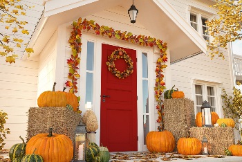 autumn decorated house with pumpkins and hay