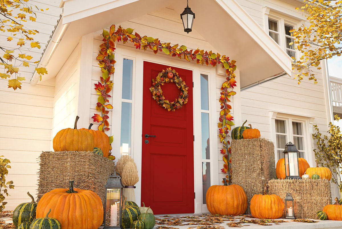 autumn decorated house with pumpkins and hay