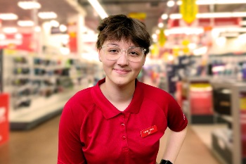 Teenage boy standing in a farm supply store