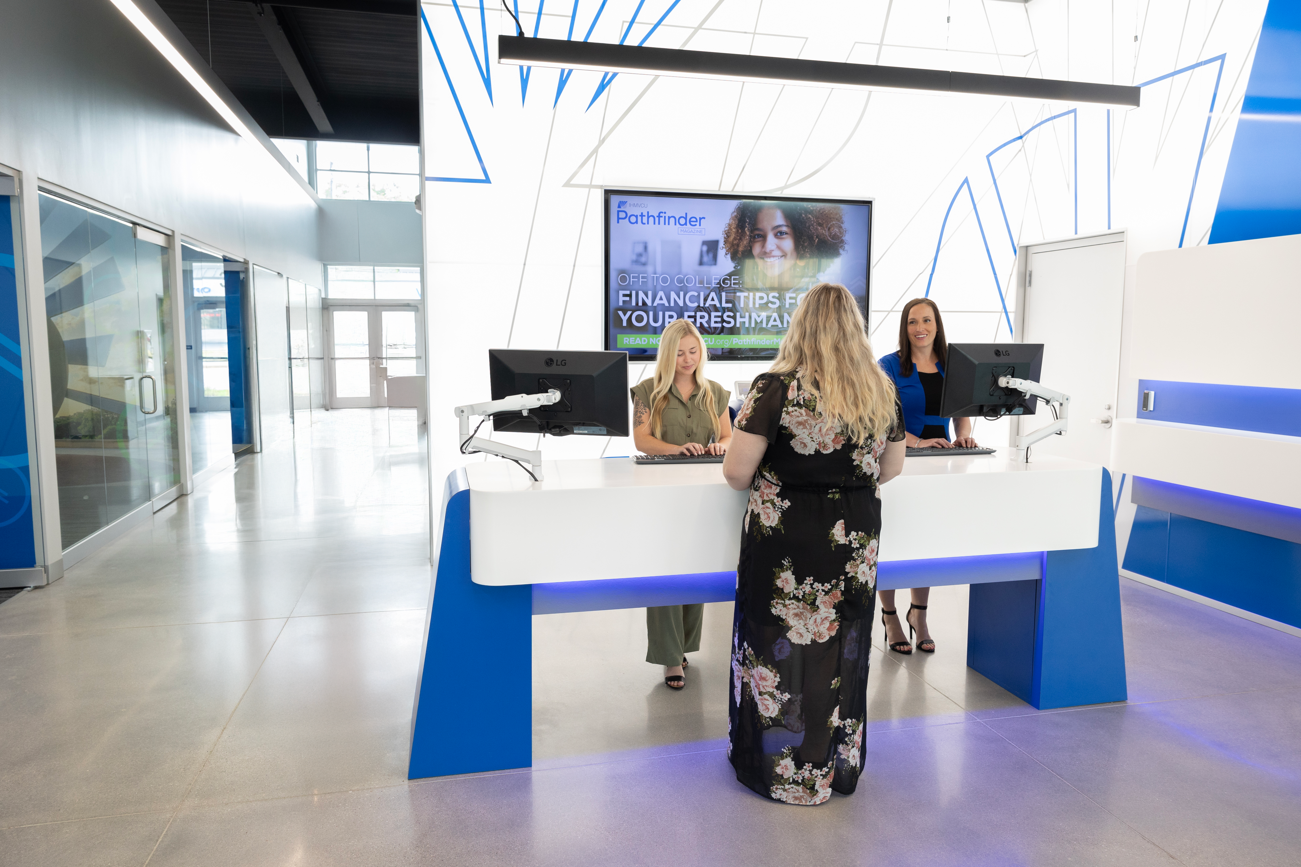 IHMVCU Credit Union staff helping a member