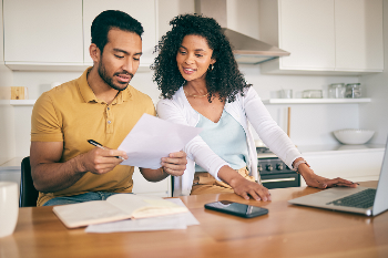 couple looking at finances at their kitchen table