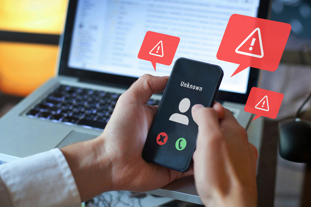phone in hand with alerts for fraud