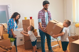Couple with two kids and moving boxes
