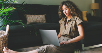 Woman sitting on the floor on her laptop