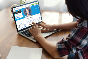Young girl on computer with IH Scholarship page up