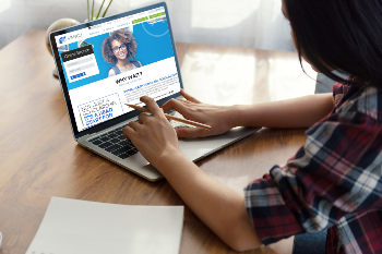 Young girl on computer with IH Scholarship page up