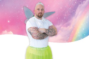 Man standing with wings on pretending to be tooth fairy