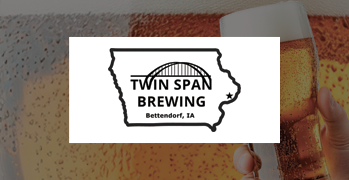 Picture of person holding a glass of beer with iowa twin span brewing logo