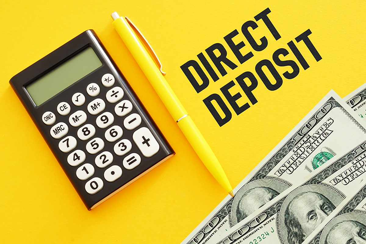 Calculator, pen and cash with the text direct deposit
