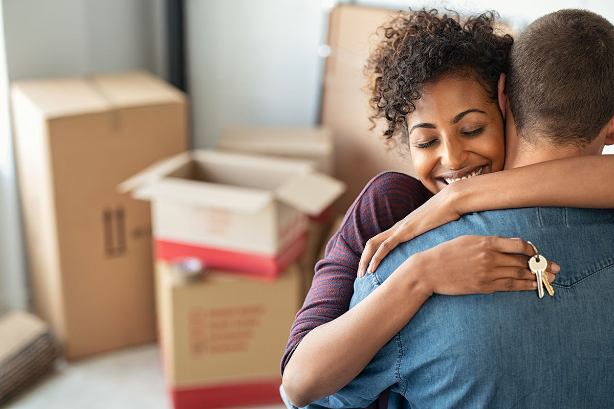 Woman hugging man while holding keys