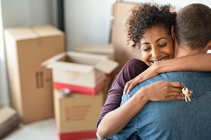 Woman hugging man while holding keys 