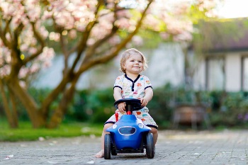 toddler girl in toy car