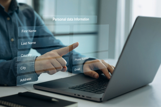 Person on computer filling out personal information