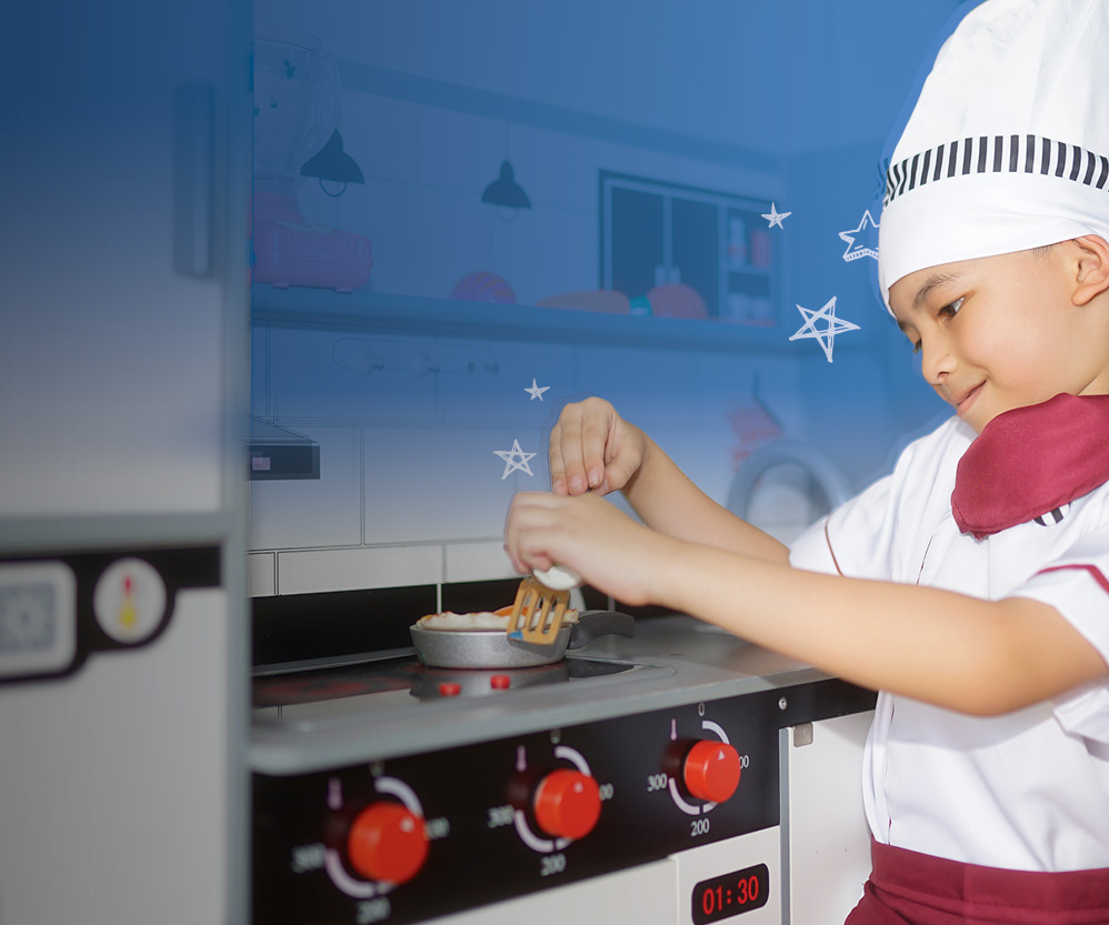 Young boy in a chef hat cooking up something good
