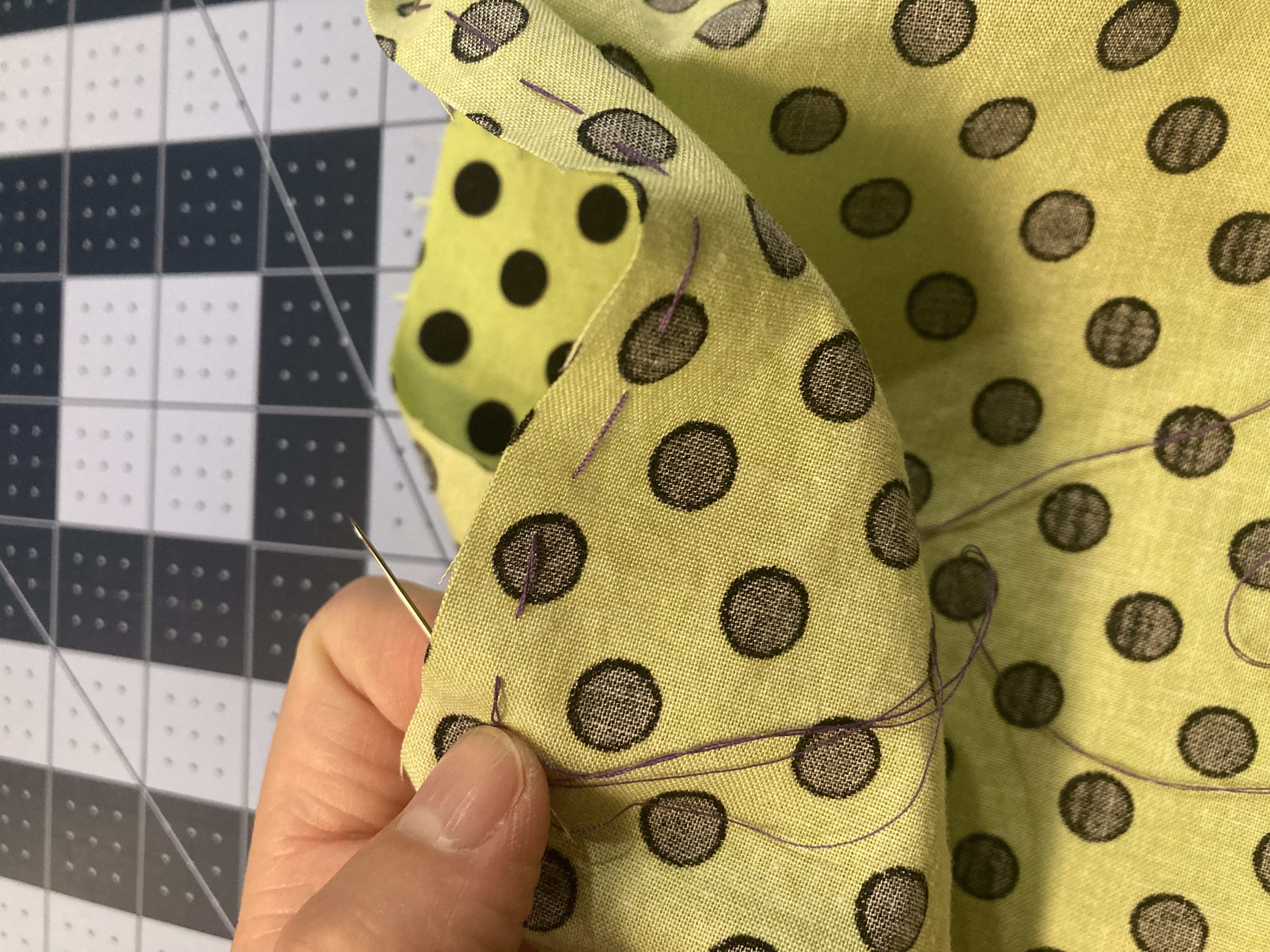Using needle to sew through fabric