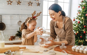 Mother and daughter baking in kitchen