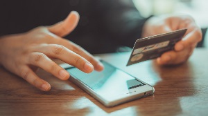 Man holding credit card and phone