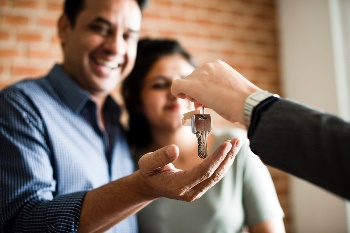 Couple being handed house keys