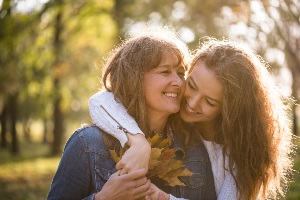 Aging mother and daughter smiling