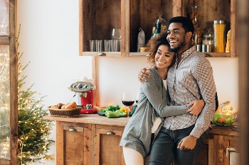 couple hugging in kitchen