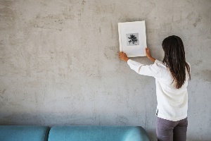 Woman hanging picture