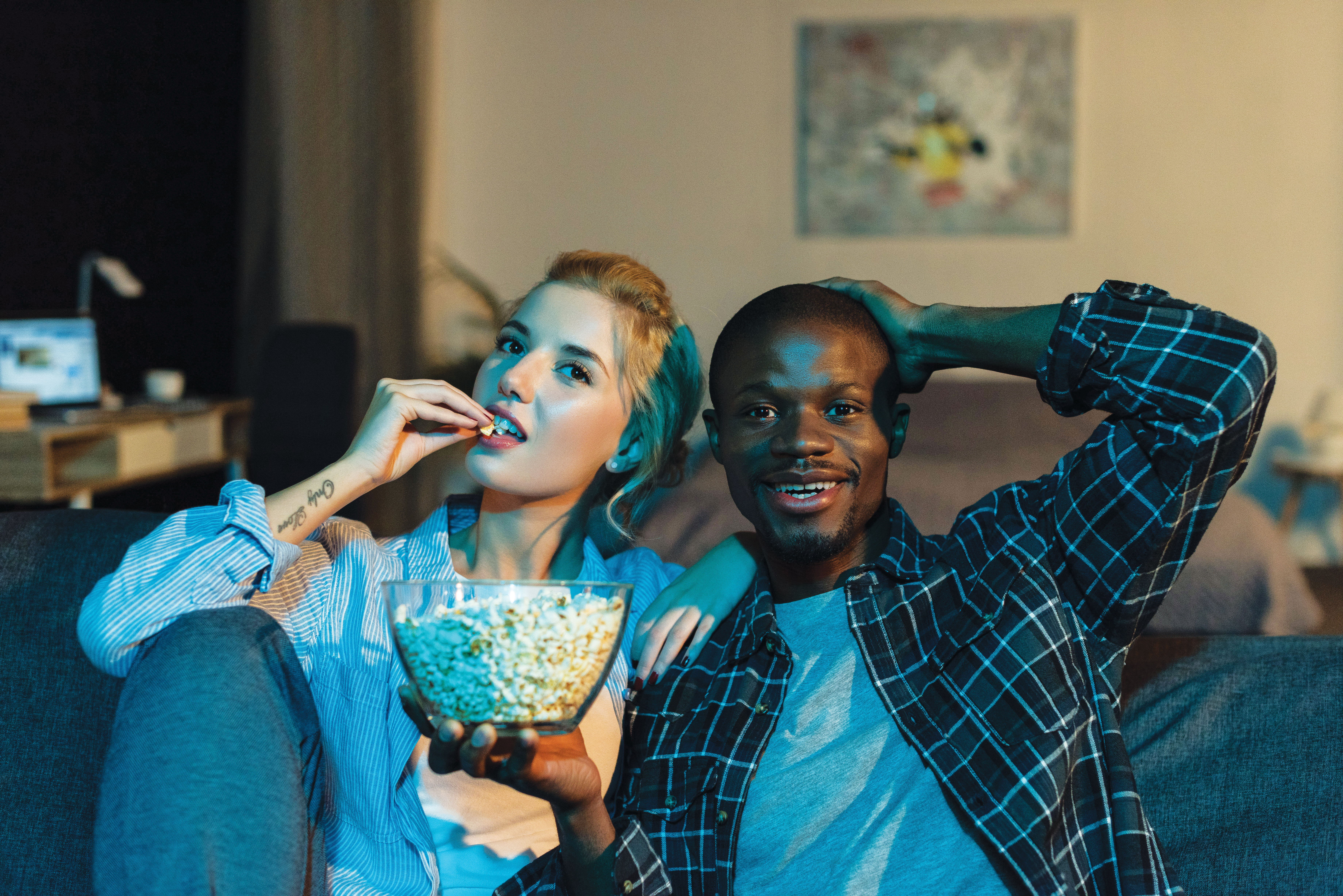 Couple with popcorn watching tv