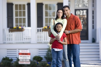 family in front of new home