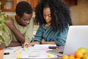 Black couple reviewing  bills