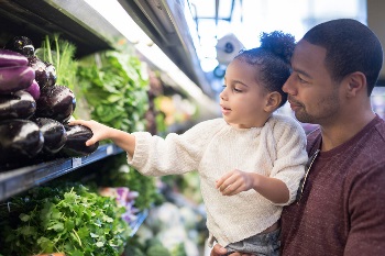 Dad and daughter grocery shopping