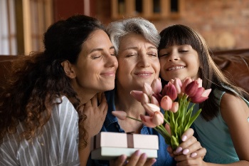 Grandmother, daughter and granddaughter hugging