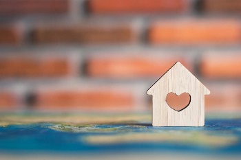 Small wooden home token with a heart in the middle