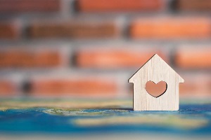 Small wooden home token with a heart in the middle