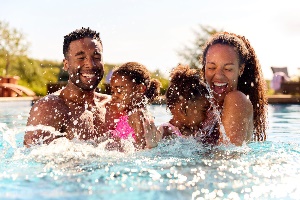 Family splashing in pool