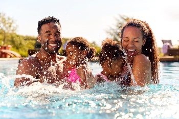 Family splashing in pool