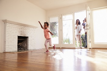 little girl running in new home