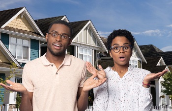 Couple looking confused with homes behind them
