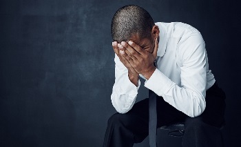 disappointed man wondering what to do next after job loss