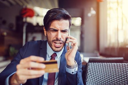 man upset about his credit card_small man on phone yelling about credit card