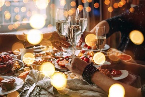 Toasting wine over a table of food