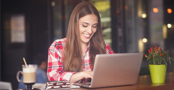 Woman at a coffee shop on her laptop