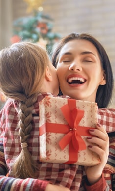 Woman hugging child with present