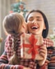 Woman hugging child with present