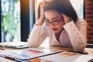 Woman looking at financials and stressed
