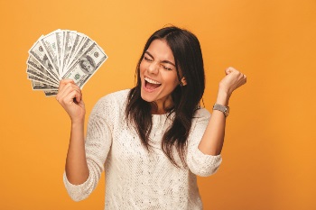 Girl holding cash looking excited