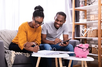 woman and man sitting down discussing their finances