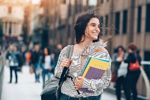 college girl smiling because she has smart money habits