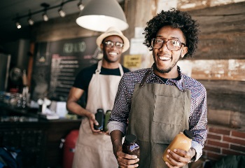 smiling business owners in their store